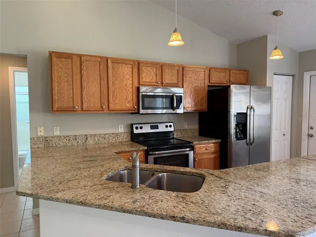 a view of a kitchen with a sink and a chandelier