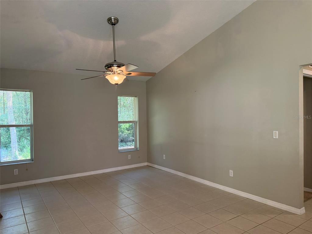 9735 West Dunnellon Road, Unit 31 Crystal River, FL 34428 - Photo 34 of 55 an empty room with windows and chandelier