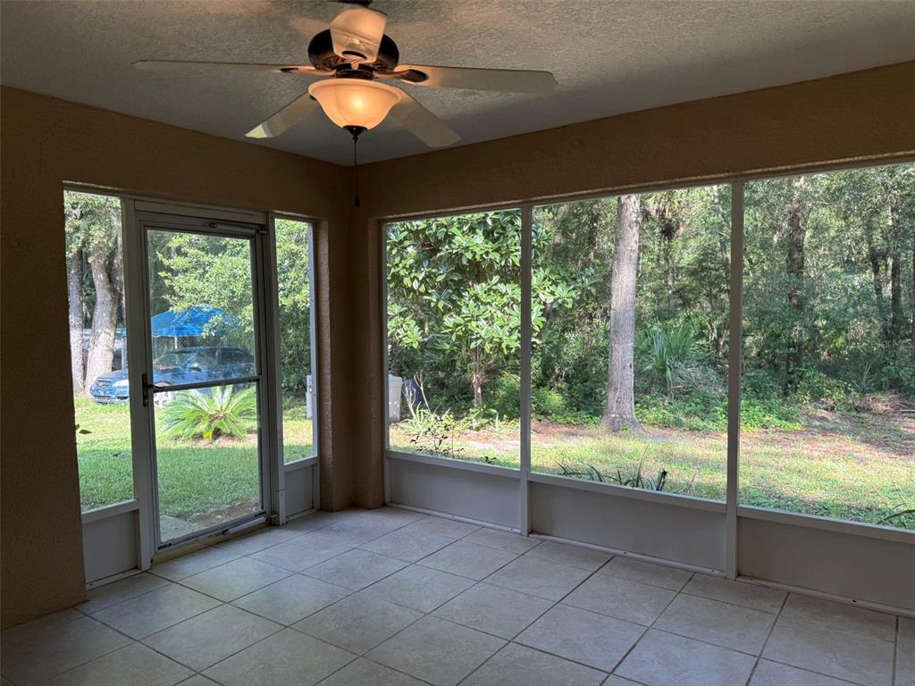 9735 West Dunnellon Road, Unit 31 Crystal River, FL 34428 - Photo 38 of 55 a view of an empty room with a floor to ceiling window and an entrance