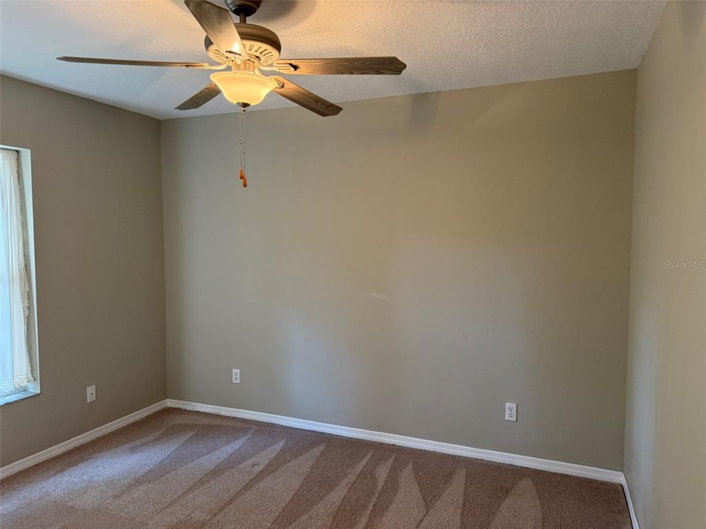 9735 West Dunnellon Road, Unit 31 Crystal River, FL 34428 - Photo 54 of 55 an empty room with a window and a fan