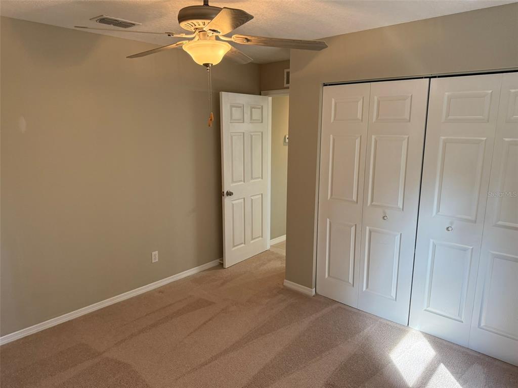 9735 West Dunnellon Road, Unit 31 Crystal River, FL 34428 - Photo 55 of 55 a view of a bedroom with a chandelier fan and a window