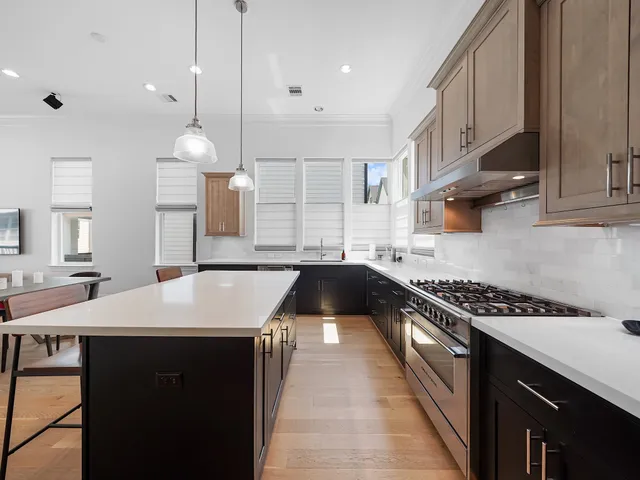 a kitchen with a sink a stove and cabinets