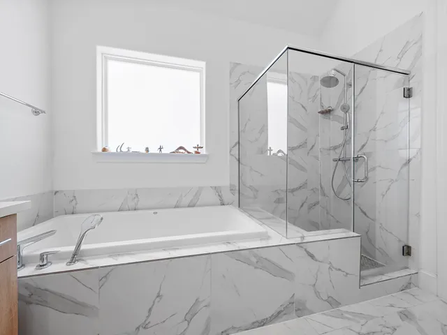 a white bath tub sitting next to a shower