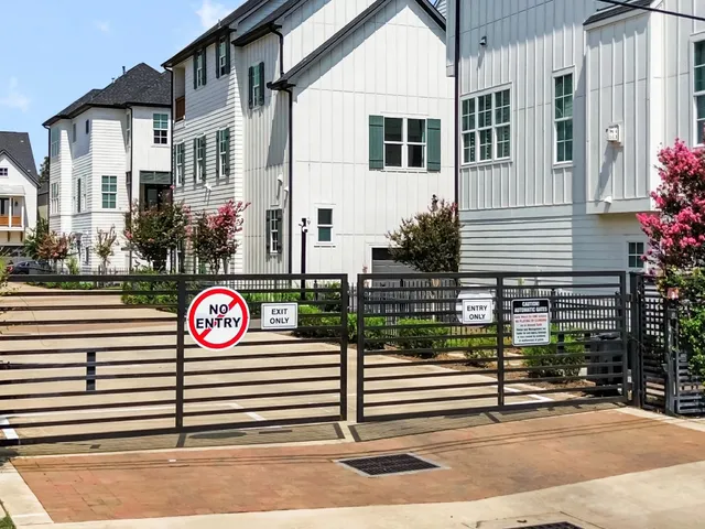 a view of a house with a small yard and wooden fence