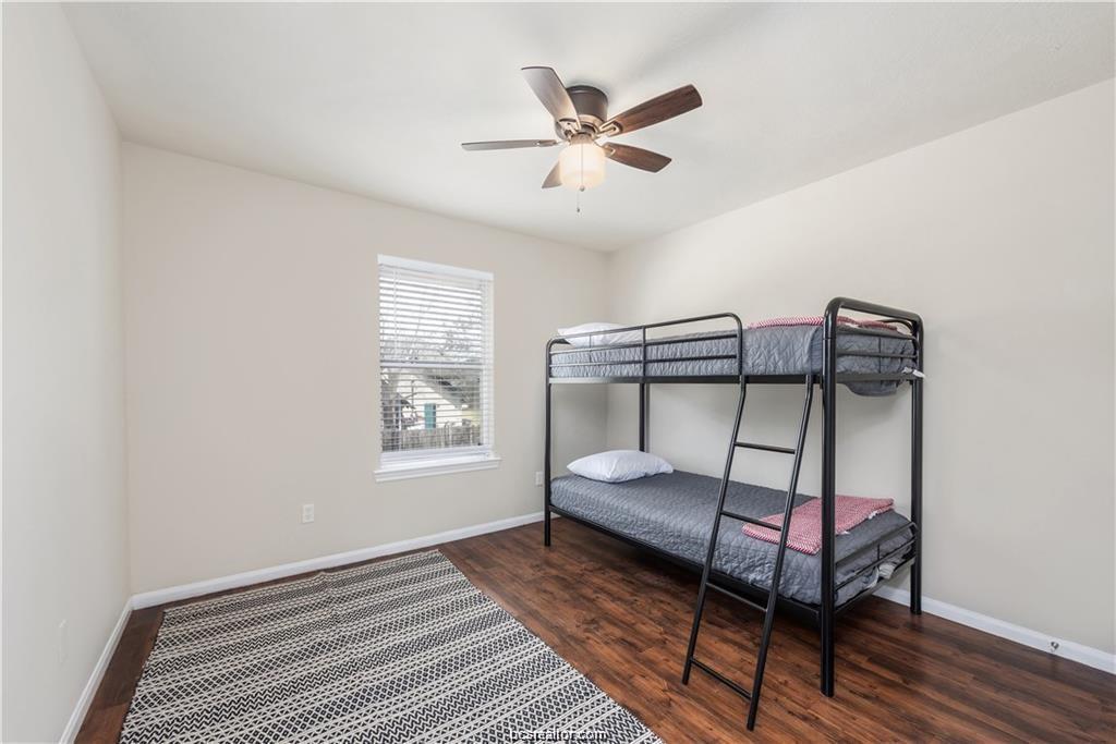 1217 Oney Hervey Drive College Station, TX 77840 - Photo 15 of 22 a bedroom with a bed and a chandelier