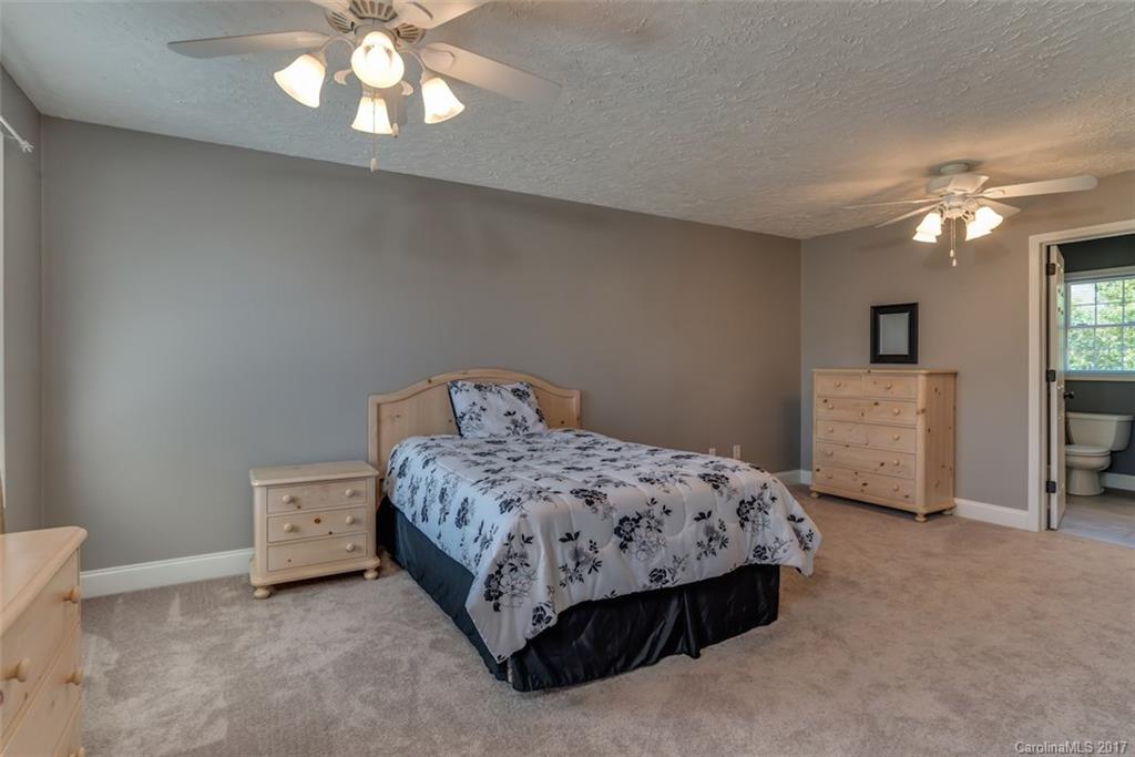 4144 Us 64/74a Road Rutherfordton, NC 28139 - Photo 14 of 24 a bedroom with a bed and a chandelier