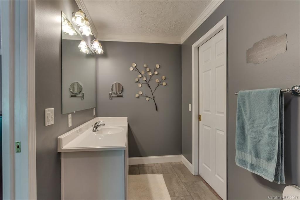 4144 Us 64/74a Road Rutherfordton, NC 28139 - Photo 17 of 24 a bathroom with a sink a light fixture and a mirror