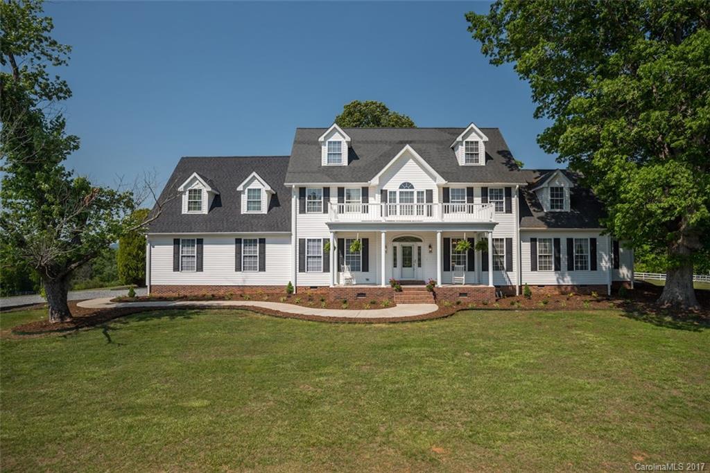 4144 Us 64/74a Road Rutherfordton, NC 28139 - Photo 19 of 24 a front view of a house with a garden and trees