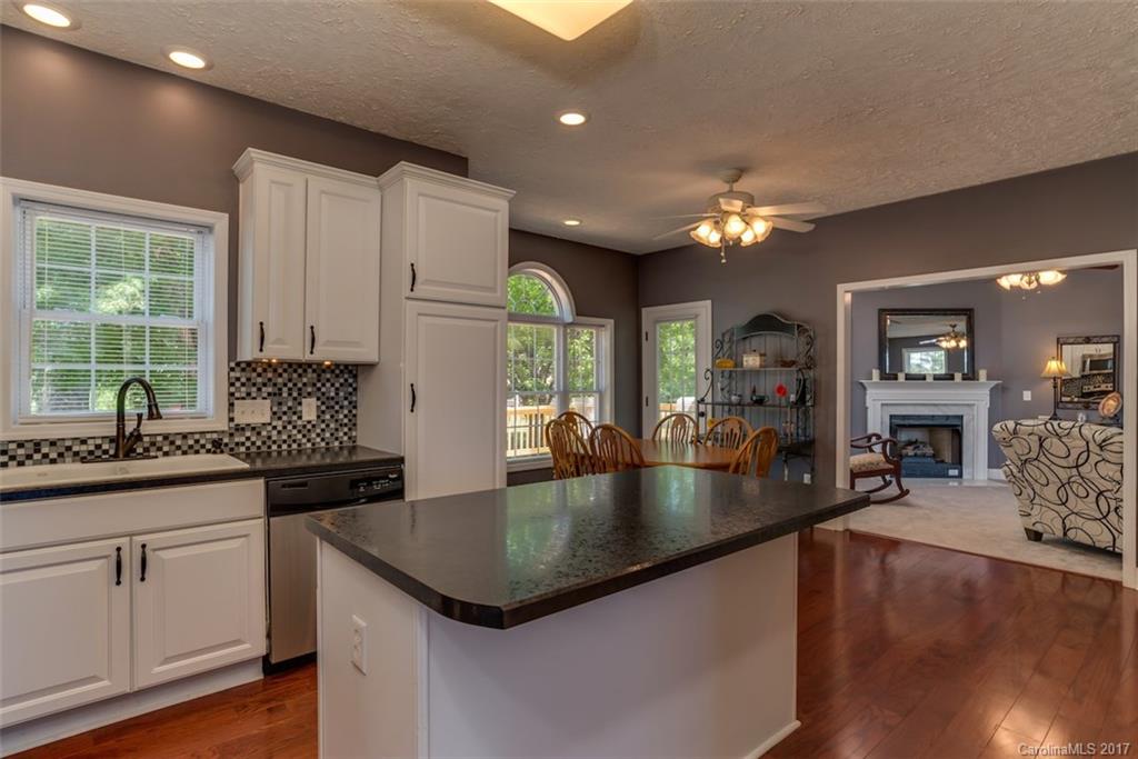 4144 Us 64/74a Road Rutherfordton, NC 28139 - Photo 6 of 24 a kitchen with granite countertop a sink a counter top space and living room view