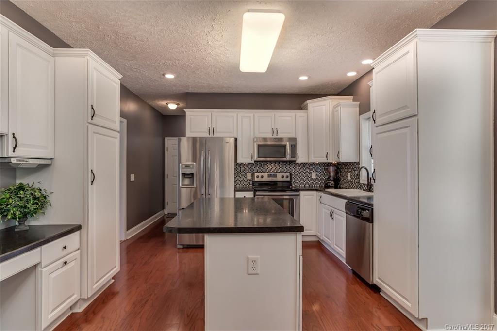 4144 Us 64/74a Road Rutherfordton, NC 28139 - Photo 7 of 24 a kitchen with stainless steel appliances a refrigerator sink stove microwave and cabinets