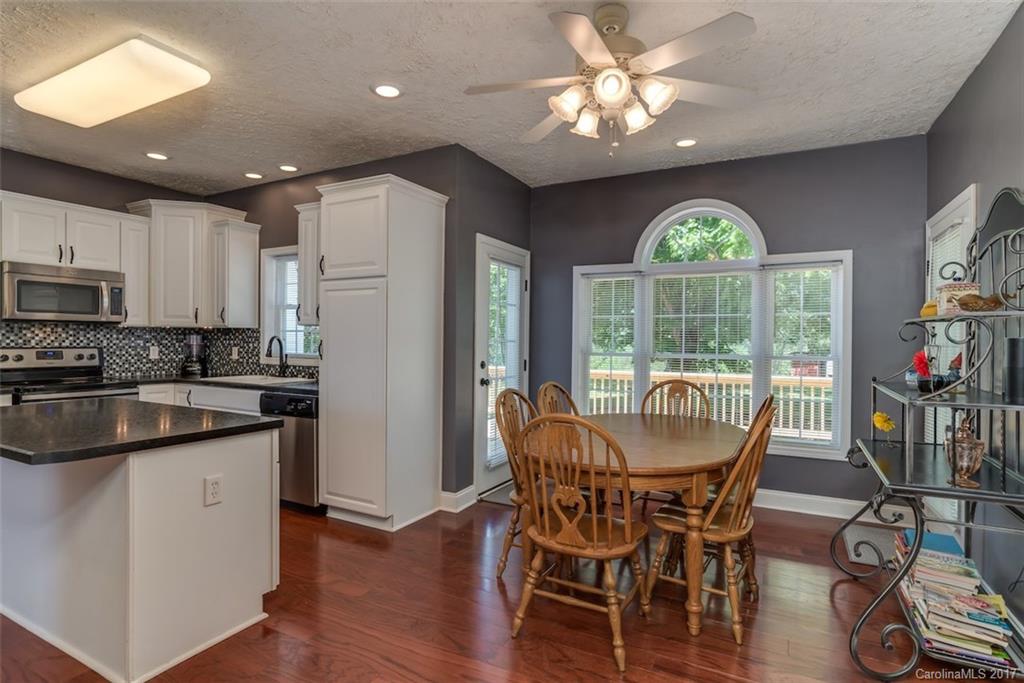 4144 Us 64/74a Road Rutherfordton, NC 28139 - Photo 8 of 24 a view of a dining room with furniture a chandelier and wooden floor