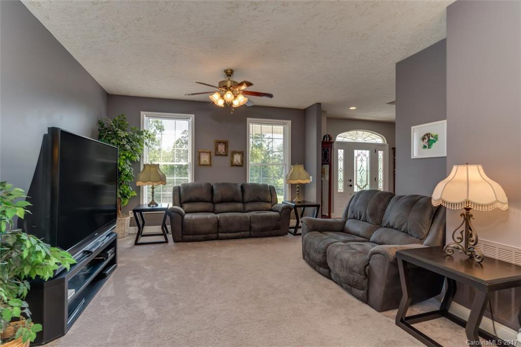 4144 Us 64/74a Road Rutherfordton, NC 28139 - Photo 9 of 24 a living room with furniture a chandelier and a flat screen tv