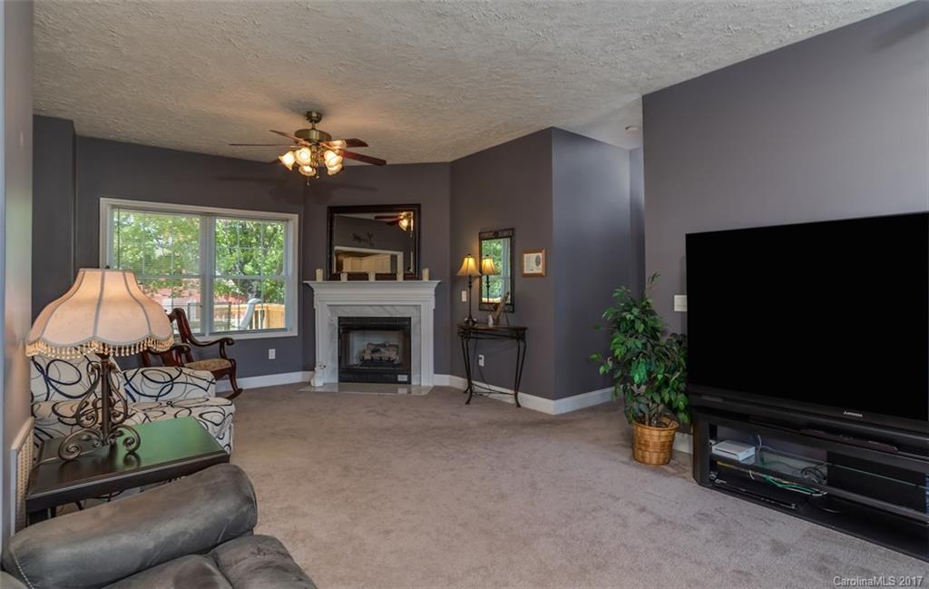 4144 Us 64/74a Road Rutherfordton, NC 28139 - Photo 10 of 24 a living room with furniture a fireplace and a flat screen tv