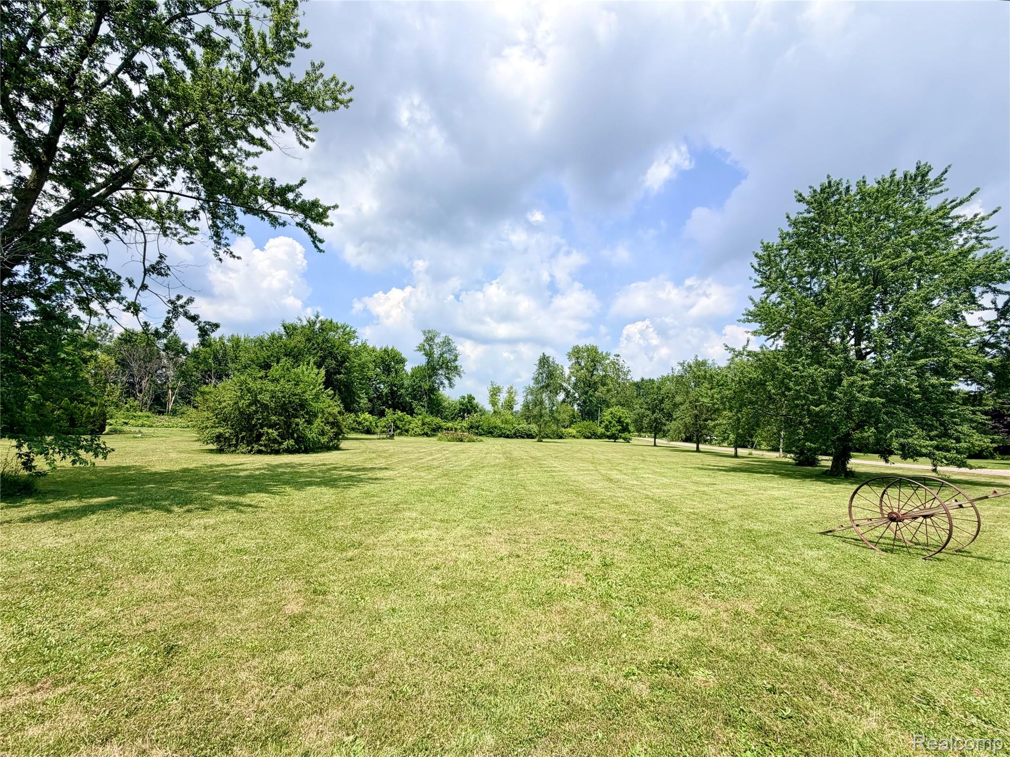 3840 East Dunbar Road Monroe, MI 48161 - Photo 10 of 38 Expansive green lawn surrounded by mature trees, creating a natural boundary