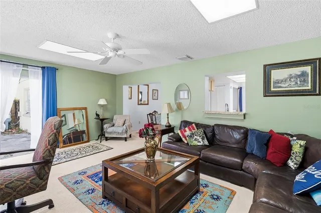 a bedroom with a bed and painting on the wall