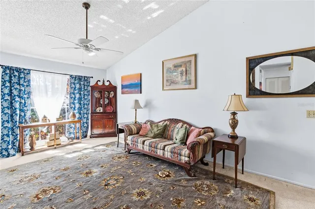 a open kitchen with stainless steel appliances granite countertop a stove a refrigerator a kitchen island a dining table and chairs