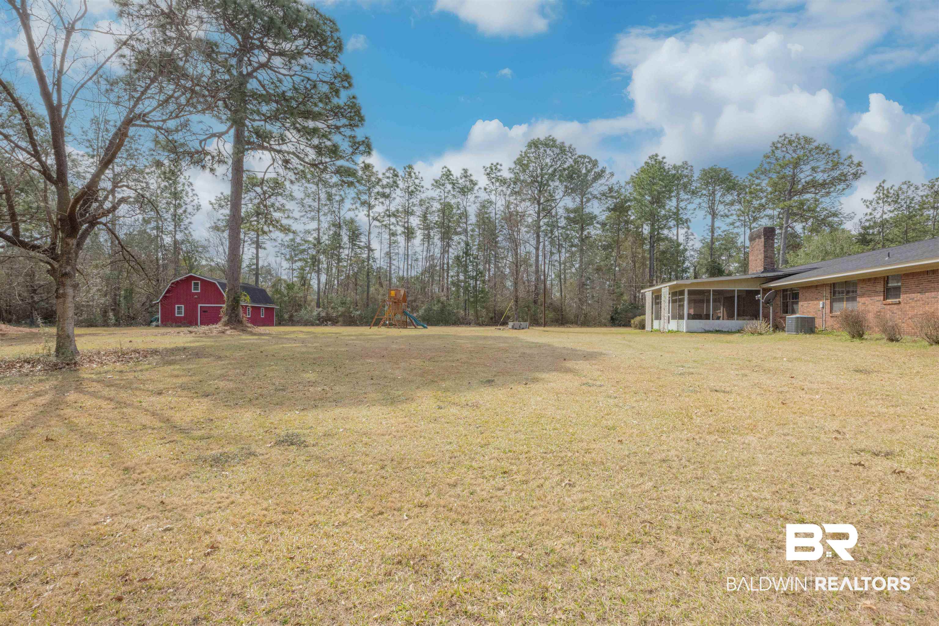 47580 Rabun Road Bay Minette, AL 36507 - Photo 46 of 55 View of yard featuring a barn, a sunroom, central air condition unit, and an outbuilding