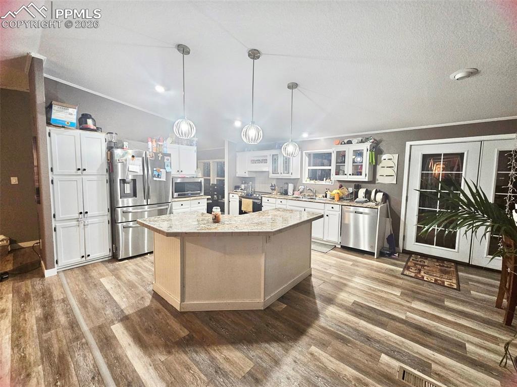 5633 Antelope Road Fountain, CO 80817 - Photo 3 of 19 a large white kitchen with a large window and stainless steel appliances