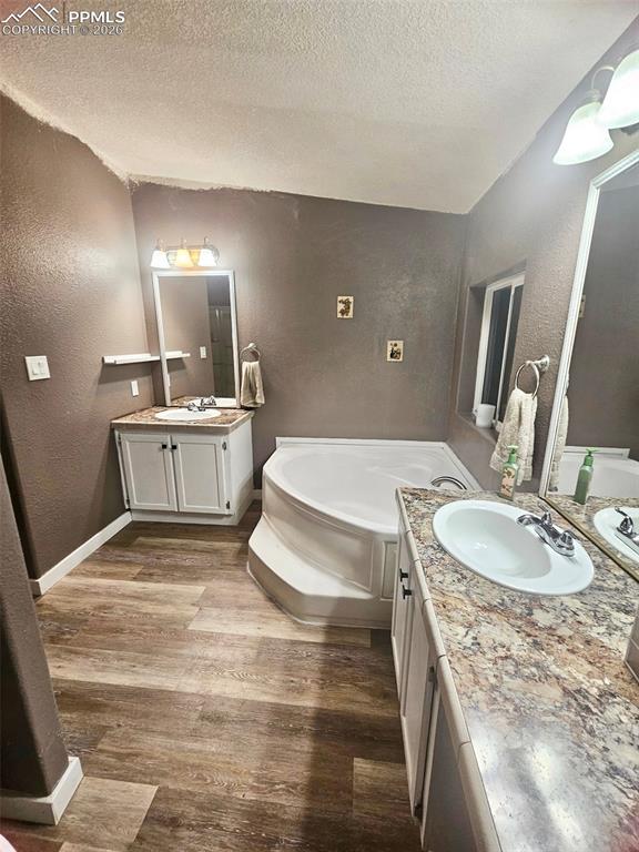 5633 Antelope Road Fountain, CO 80817 - Photo 6 of 19 a spacious bathroom with a granite countertop sink a toilet and mirror