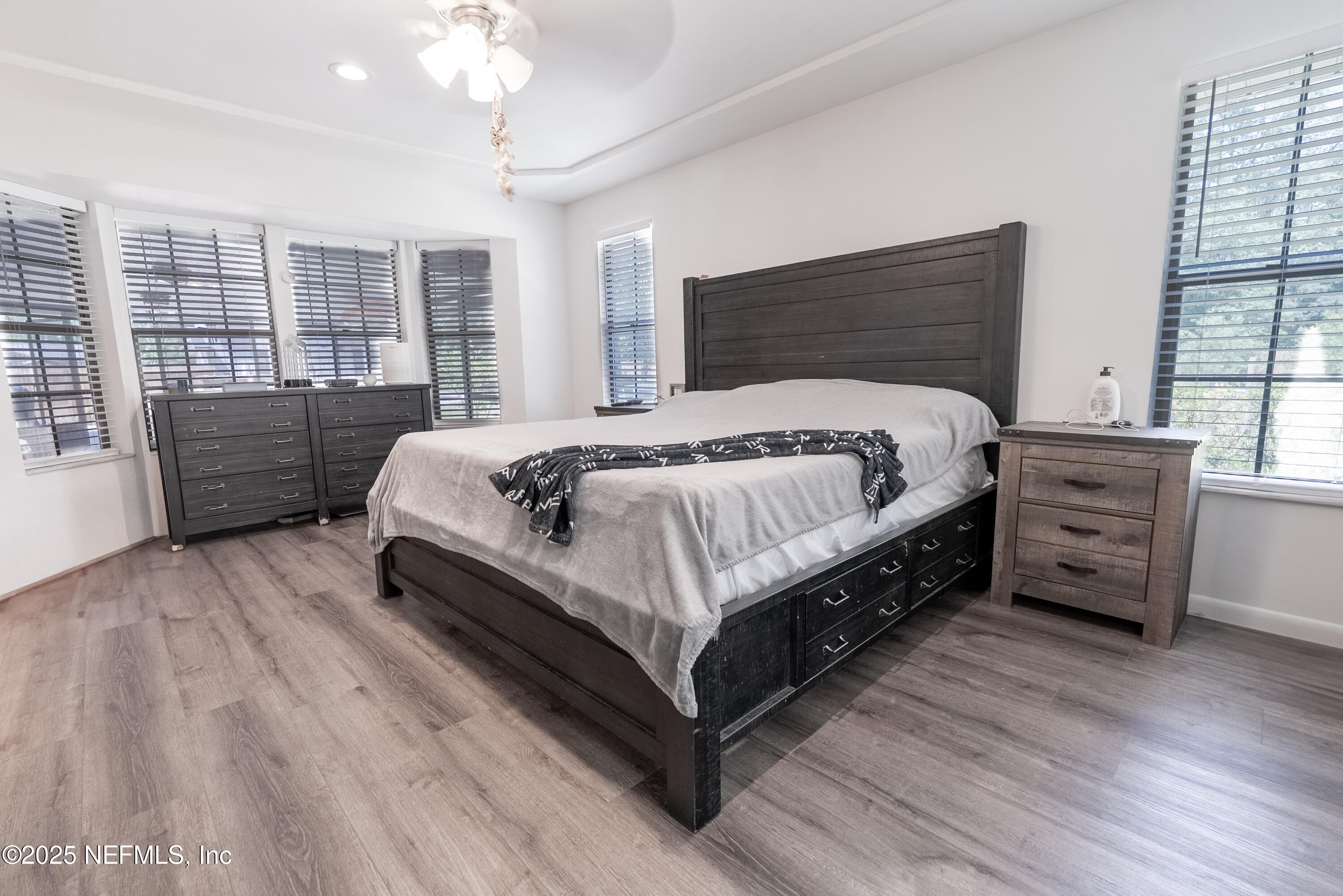 1701 Jones Road Jacksonville, FL 32220 - Photo 12 of 41 a large bedroom with a bed and wooden floor