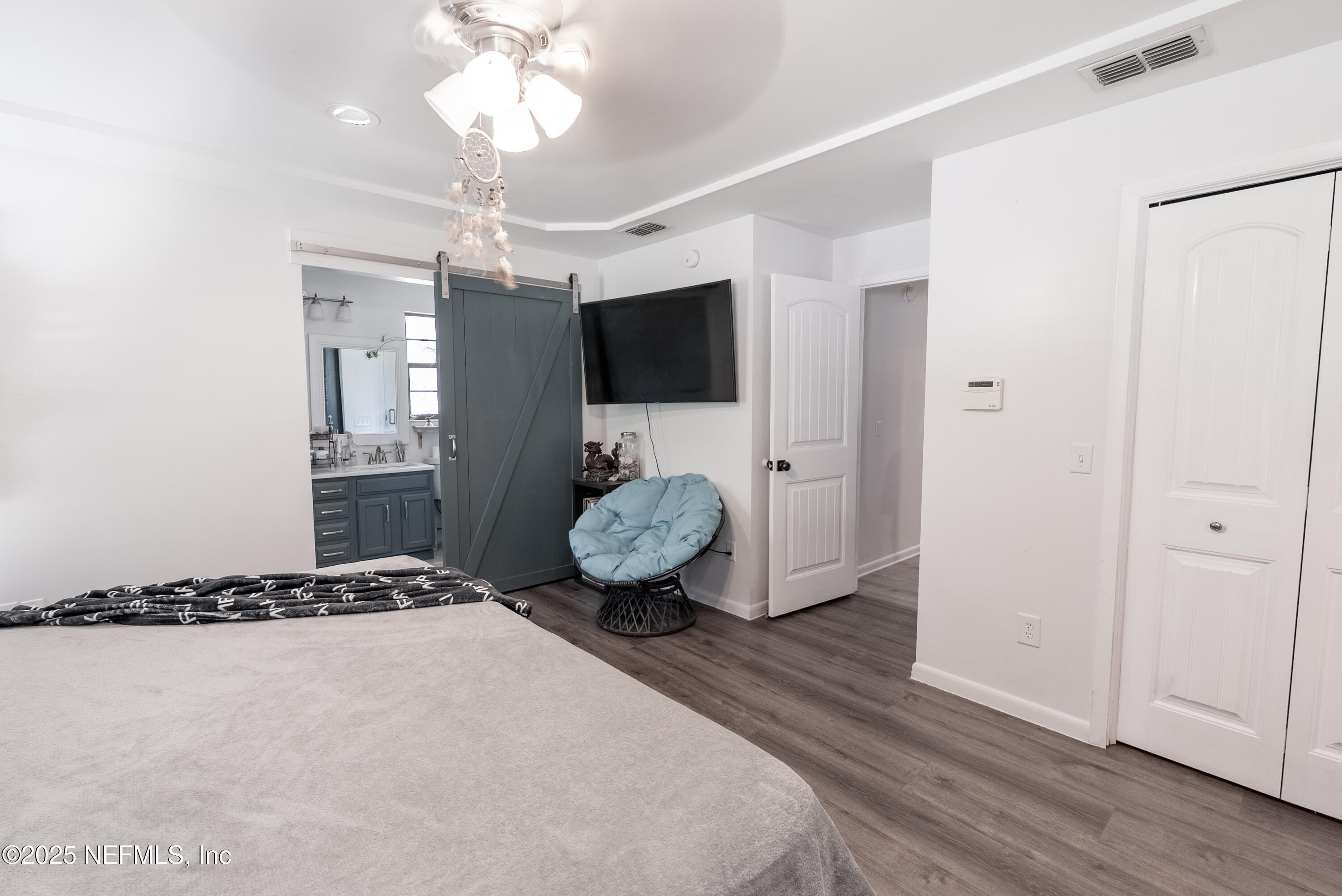1701 Jones Road Jacksonville, FL 32220 - Photo 13 of 41 a spacious bedroom with a bed and a flat tv screen on dresser