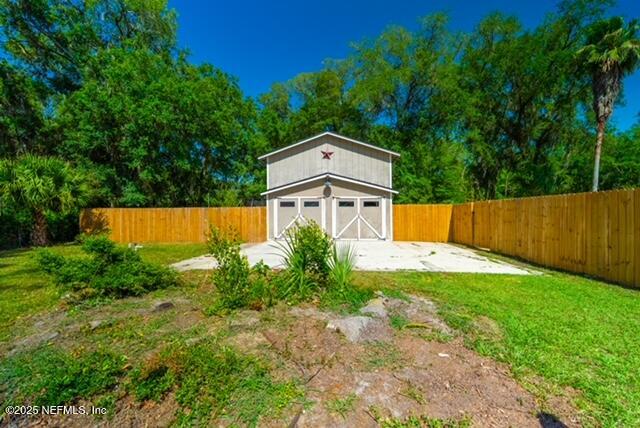 1701 Jones Road Jacksonville, FL 32220 - Photo 29 of 41 a view of a back yard with green space and wooden fence
