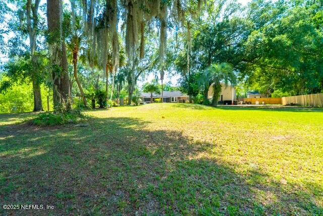 1701 Jones Road Jacksonville, FL 32220 - Photo 39 of 41 a view of a swimming pool with lawn chairs and large trees