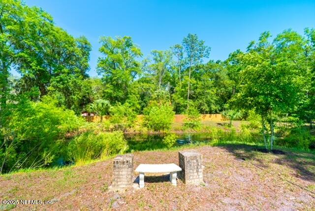 1701 Jones Road Jacksonville, FL 32220 - Photo 40 of 41 a wooden bench sitting in the middle of a yard