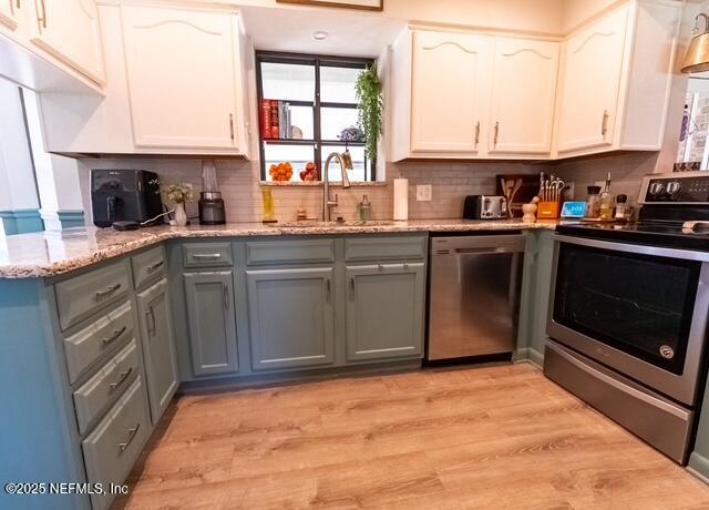 1701 Jones Road Jacksonville, FL 32220 - Photo 9 of 41 a kitchen with stainless steel appliances granite countertop a stove a sink and a microwave