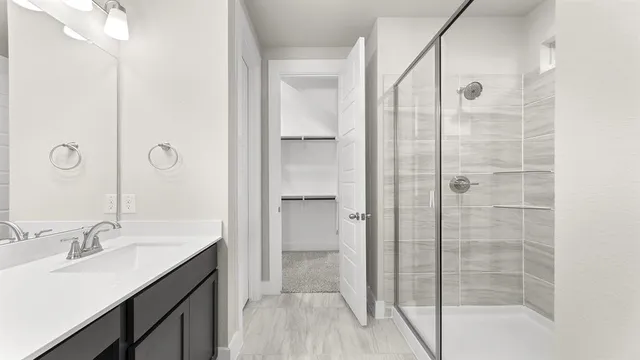 a bathroom with a double vanity sink a mirror and a shower