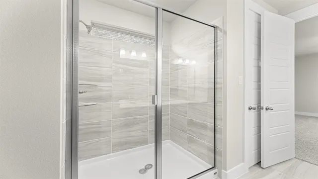 a bathroom with a shower sink and mirror