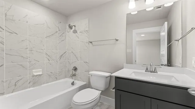 an empty room with a bathroom and a window