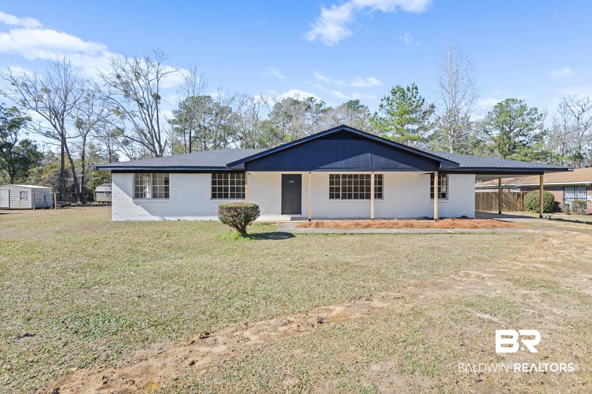 910 Moran Street Bay Minette, AL 36507 - Photo 1 of 20 Ranch-style home featuring a porch, a front yard, an attached carport, and brick siding