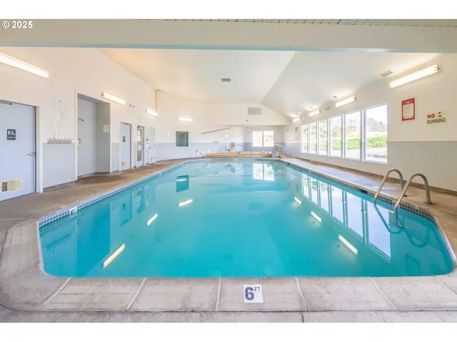 a living room with furniture and a pool table