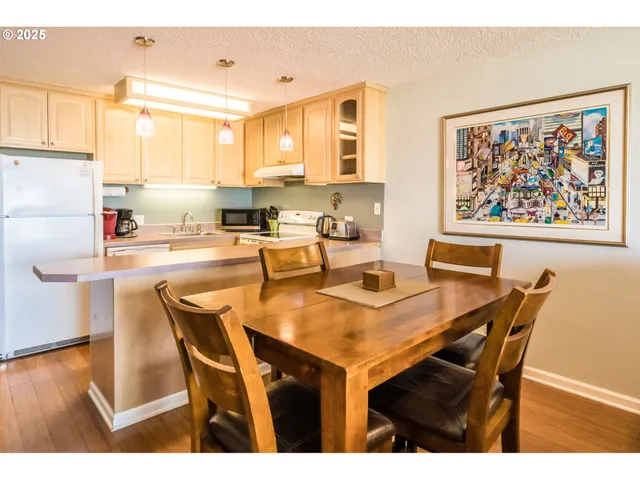 a dining room with furniture and wooden floor