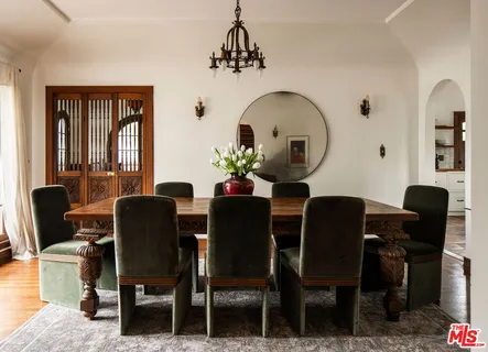 a view of a dining room with a table and chairs