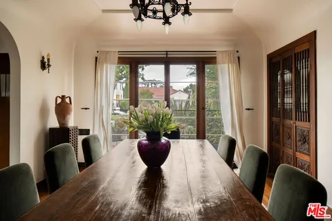 a dining room with furniture and wooden floor