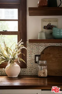 a view of a balcony with chairs and wooden floor