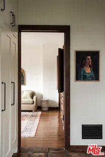 a view of entryway and hall with wooden floor