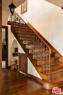 a bedroom with a bed and large windows