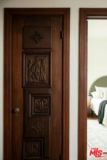 a bedroom with a bed and a television