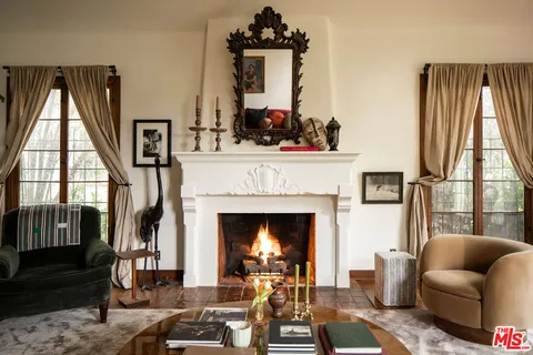 a living room with furniture a fireplace and windows