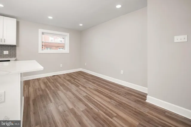 a view of wooden floor and windows in a room
