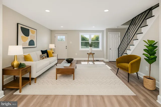 a living room with furniture and a potted plant