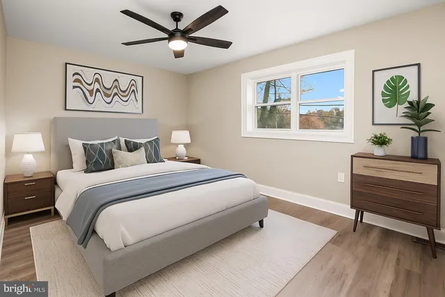 a bedroom with a bed and a painting on the wall