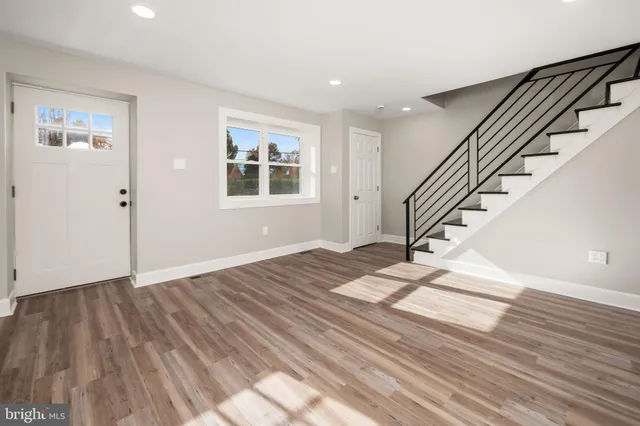 a view of entryway and hall with wooden floor