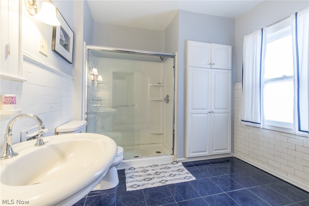 2649 Edgehill Road Cleveland, OH 44106 - Photo 29 of 33 Bathroom with subway tile, linen closet and glassed in shower. The window gives good natural light.