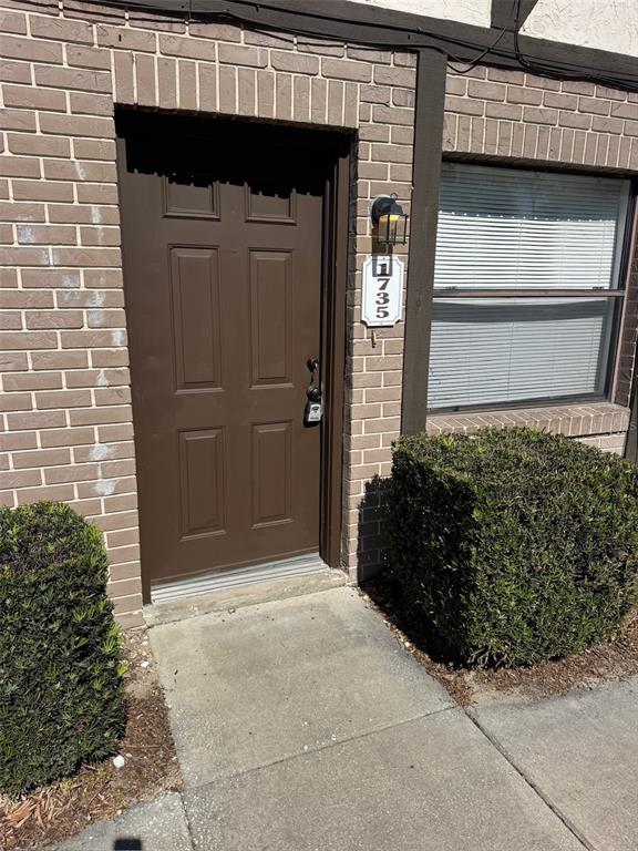 1735 Northeast 14th Street Ocala, FL 34470 - Photo 2 of 17 a front view of a house with a garage