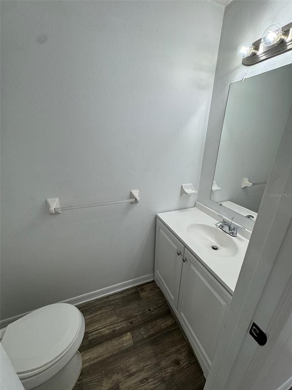 1735 Northeast 14th Street Ocala, FL 34470 - Photo 6 of 17 a bathroom with a toilet sink and mirror