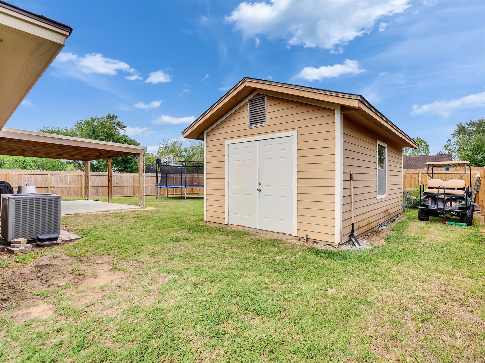 101 North Wagon Lane Angleton, TX 77515 - Photo 19 of 23 a view of a backyard with a garden